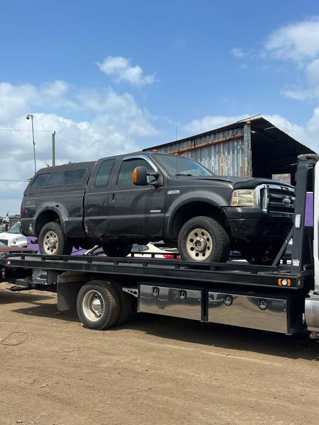 A pickup truck secured on a flatbed tow truck in Miami, Florida.