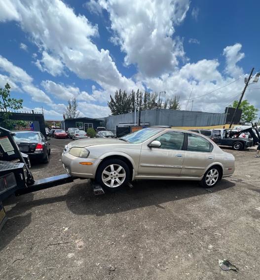 A sedan hooked up to a wheel-lift tow truck in North Lauderdale, Florida.