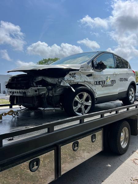 A wrecked SUV on a flatbed tow truck in Hallandale Beach.